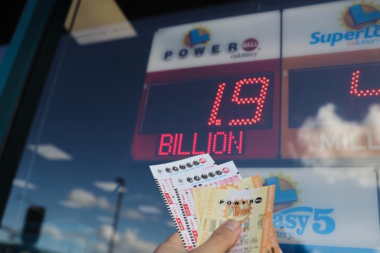 CALIFORNIA, USA - NOVEMBER 7: Powerball sign and lottery tickets are seen at a 7-Eleven store in Milpitas, California, United States on November 7, 2022. Today's Powerball jackpot hits a record $1.9 billion. The largest Powerball jackpot ever won was in January 2016 when three winners split a prize advertised at $1.586 billion. (Photo by Tayfun Coskun/Anadolu Agency via Getty Images)
