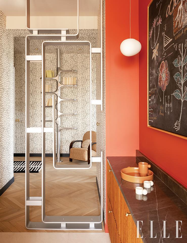 미셸 부아예가 디자인한 난간이 거실과 주방의 경계를 가르며 주방에 메탈릭한 질감을 더한다. 그 뒤로 보이는 책 선반은 로저 탈론이 1966년에 디자인한 스틸 계단을 재해석한 것. 공중에 매달린 조명은 재스퍼 모리슨이 디자인한 플로스의 ‘글로-볼’.