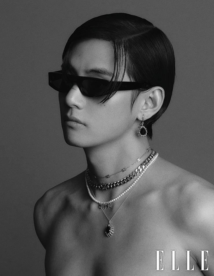 Sci-Fi Sunglasses with Black Strass Drop Earrings, Logo Choker with Bold Chain Necklace, Pearl Necklace with Logo Charm, and Black Strass Pendant Necklace are all from Celine Homme.